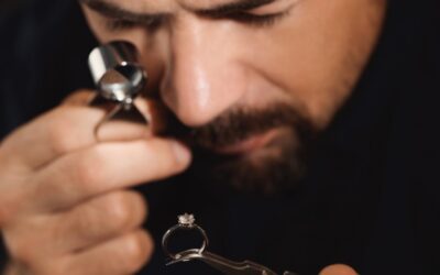 An appraiser looking at a diamond ring with a microscope to determine the appraised value