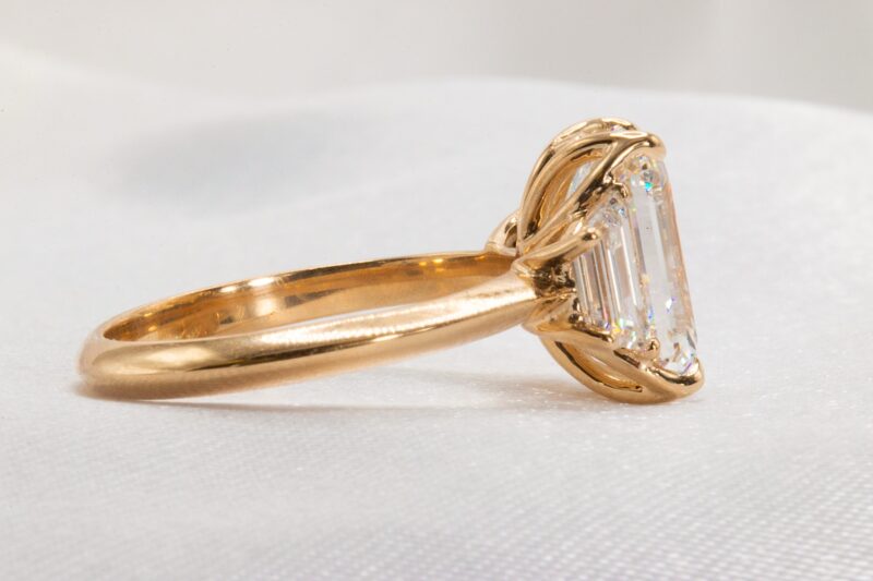 3 stone emerald cut lab diamond ring side view