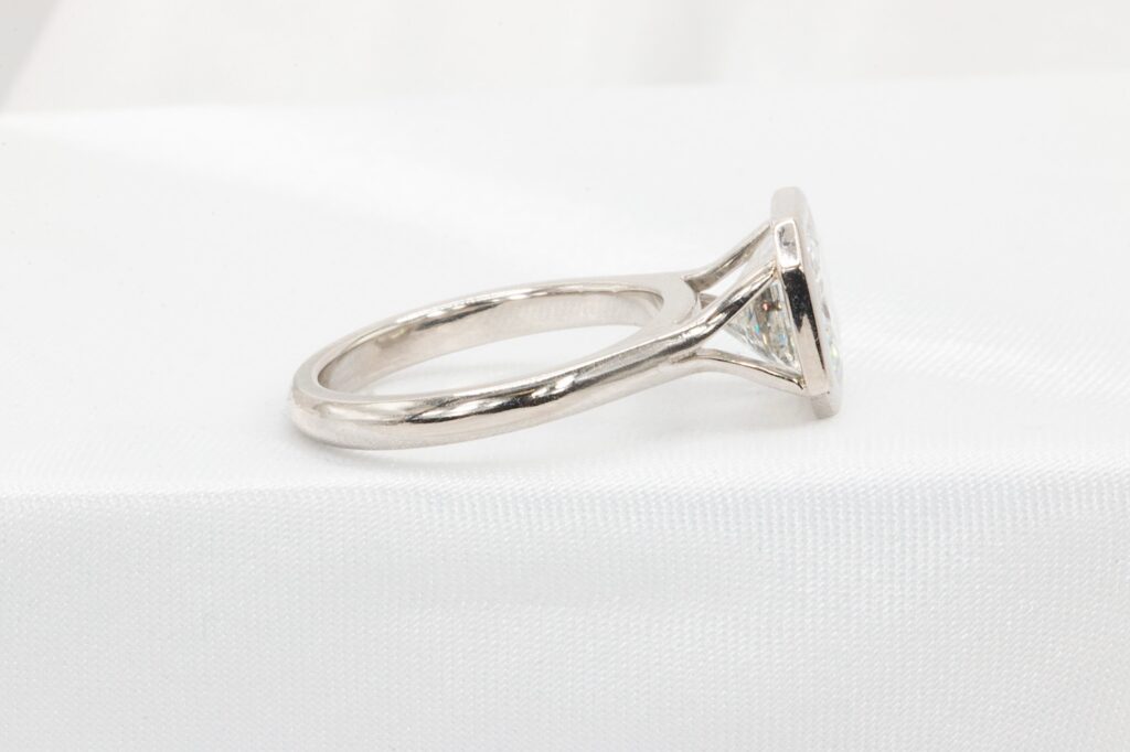 3 carat radiant cut diamond bezel ring side view