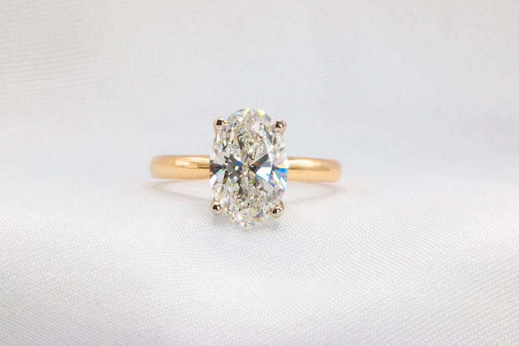 Oval cut diamond yellow gold engagement ring